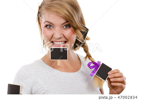 Teenage girl biting little school blackboards Teenage girl biting little school blackboards 47002834