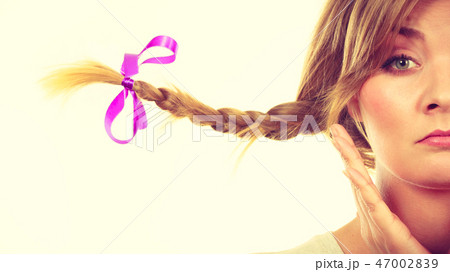 Sad teenage girl in windblown braid hair Sad teenage girl in windblown braid hair 47002839