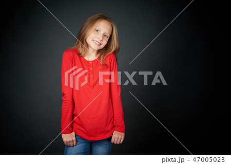 Little girl standing casually Little girl standing casually 47005023