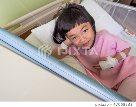Asian child girl on hospital bed 47008233