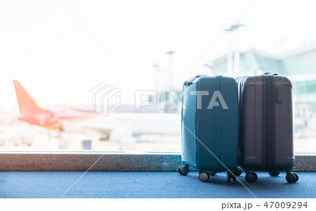 Travel luggage suitcase at the airport terminal  47009294