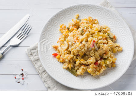 Pilaf with vegetables and chicken in a gray plate  47009502
