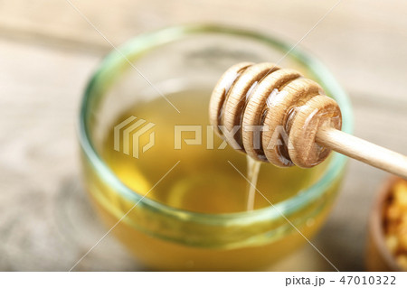 honey in a plate with a spoon for honey honey in a plate with a spoon for honey 47010322