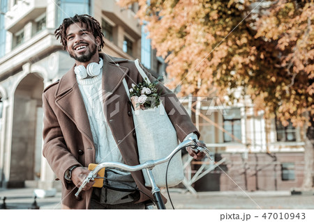 Cheerful bearded man keeping smile on his face Cheerful bearded man keeping smile on his face 47010943