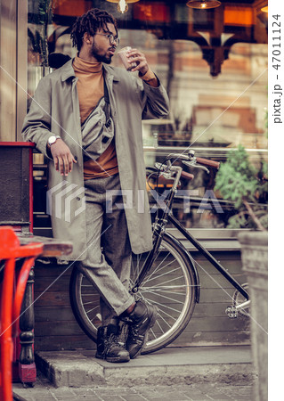 Handsome brunette man enjoying tasty hot cacao Handsome brunette man enjoying tasty hot cacao 47011124