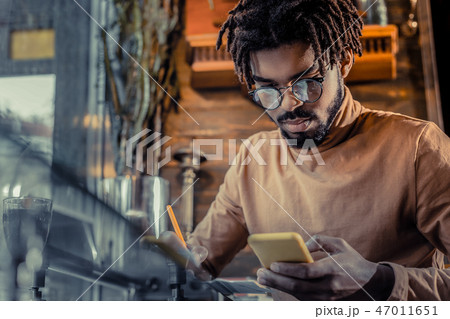 Attentive brunette man checking news in internet 47011651