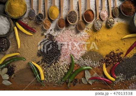 Assortment of spices in wooden bowl background 47013538