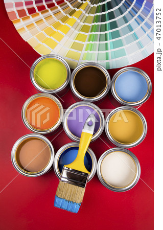 Can with paint and paintbrush, red background 47013752