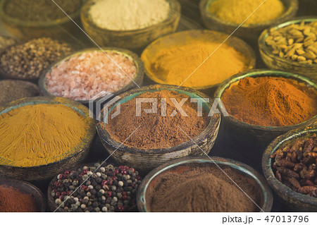 Variety of spices and herbs on kitchen table 47013796