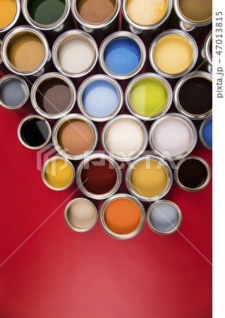 Collection of colored paints cans, red background 47013815