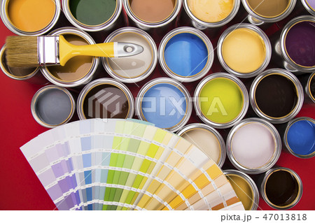 Can with paint and paintbrush, red background 47013818