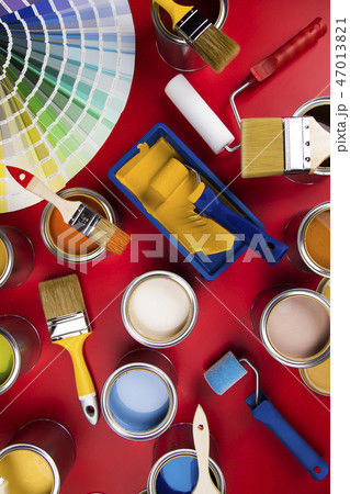 Can with paint and paintbrush, red background 47013821