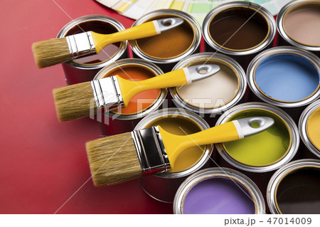 Can with paint and paintbrush, red background 47014009
