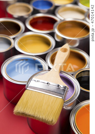 Can with paint and paintbrush, red background Can with paint and paintbrush, red background 47014142