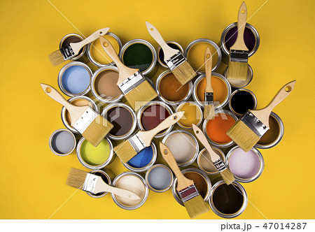 Tin cans with paint and brushes, yellow background 47014287