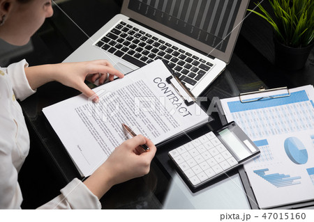employee gets acquainted with contract in stylish office 47015160