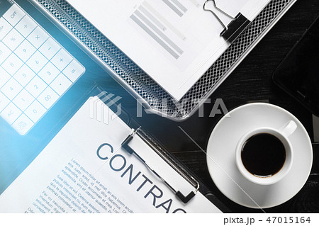 financial documents, contract and coffee Cup top view close-up 47015164