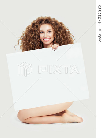 Beautiful young blonde woman holding big empty  47015885