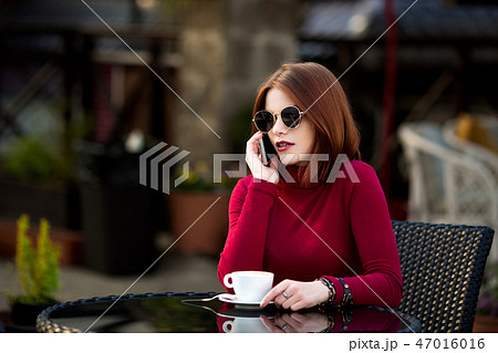 Lifestyle fashion portrait of young stylish hipster woman walking on the street. Lifestyle fashion portrait of young stylish hipster woman walking on the street. 47016016