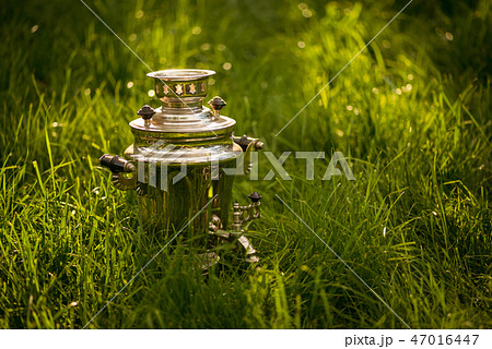 Rustic samovar on the fresh summer lawn. Copyspace 47016447