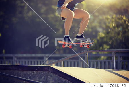 skateboarder skateboarding on skatepark 47018126