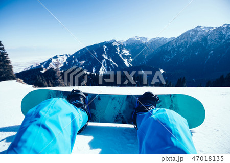 snowboarder with snowboard on winter mountain top 47018135