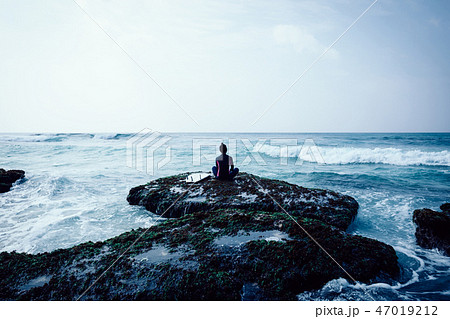 surfer meditation at the seaside cliff edge surfer meditation at the seaside cliff edge 47019212