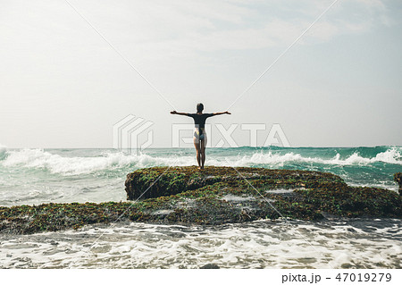 Freedom Woman outstretched arms at seaside reef Freedom Woman outstretched arms at seaside reef 47019279