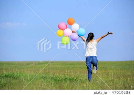 running and jumping with colored balloons outdoors running and jumping with colored balloons outdoors 47019283