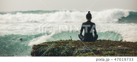 Yoga woman meditation at the seaside cliff edge Yoga woman meditation at the seaside cliff edge 47019733