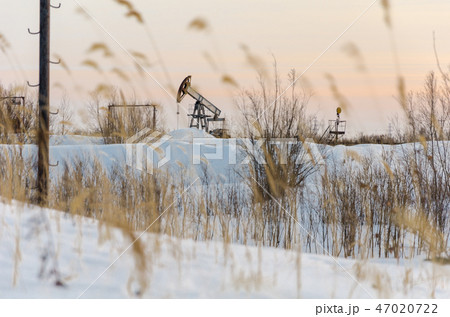 Oilfield during sunset in winter time Oilfield during sunset in winter time 47020722