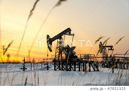 Oilfield during sunset in winter time Oilfield during sunset in winter time 47021325