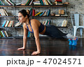 Woman doing push ups workout during fitness training on floor at home 47024571