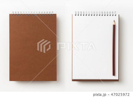 Top view of brown spiral notebook, page, pencil 47025972