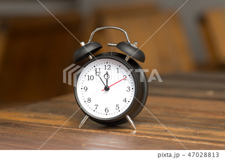 Retro clock with five minutes to twelve o'clock. 47028813