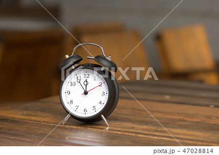 Retro clock with five minutes to twelve o'clock. 47028814