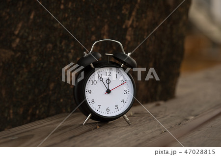 Retro clock with five minutes to twelve o'clock. 47028815