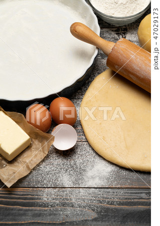 rolled and unbaked Shortcrust pastry dough recipe on wooden background 47029173