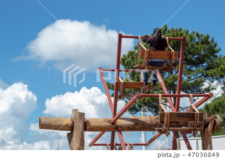 Women ride the wooden Ferris wheel. Women ride the wooden Ferris wheel. 47030849