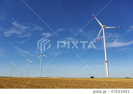 Windturbines in a yellow farmland landscape Windturbines in a yellow farmland landscape 47033401
