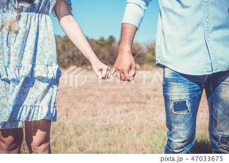 Romantic couple with clasped hands backlit Romantic couple with clasped hands backlit 47033675
