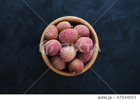 Ripe lychees on a black table. Top view. 47034055