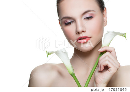 Young woman face with flowers in her hands Young woman face with flowers in her hands 47035046