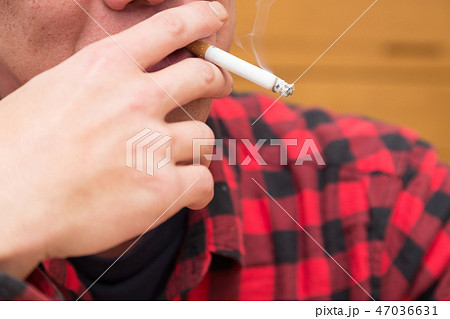 たばこを吸う男性の口元の写真素材