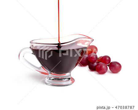 Balsamic vinegar in bowl with grape.  47038787