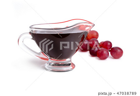 Balsamic vinegar in bowl with grape. Isolated  47038789
