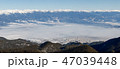 Mist covers the city at the foot of the mountains 47039448