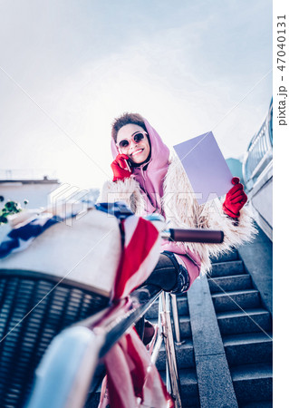 Attractive young woman having pleasant telephone talk Attractive young woman having pleasant telephone talk 47040131