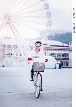 Charming female person sitting on her eco transport Charming female person sitting on her eco transport 47040498