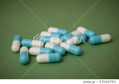 blue and white capsules and capsules  47040761